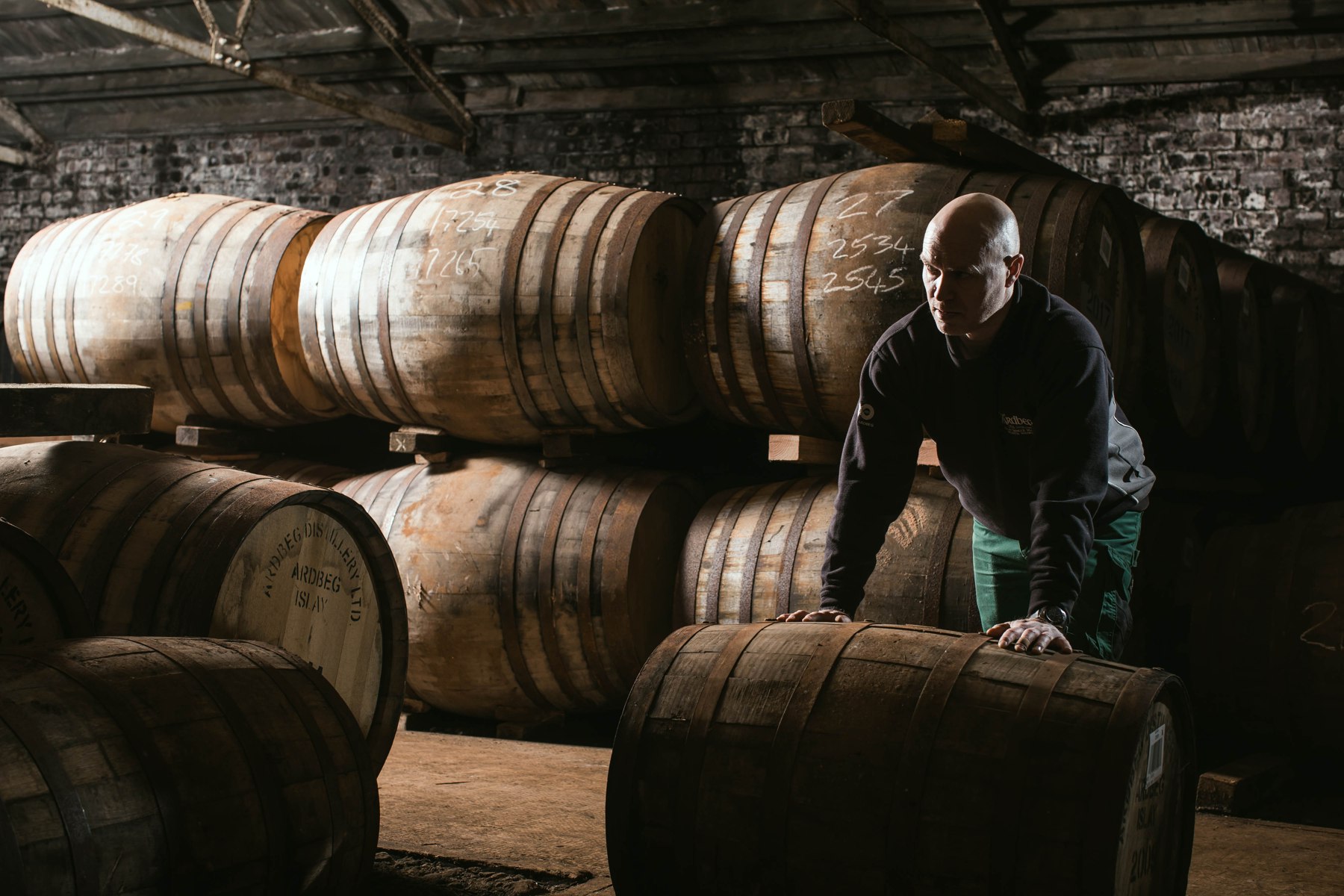 A member of the Ardbeg team moving a cask