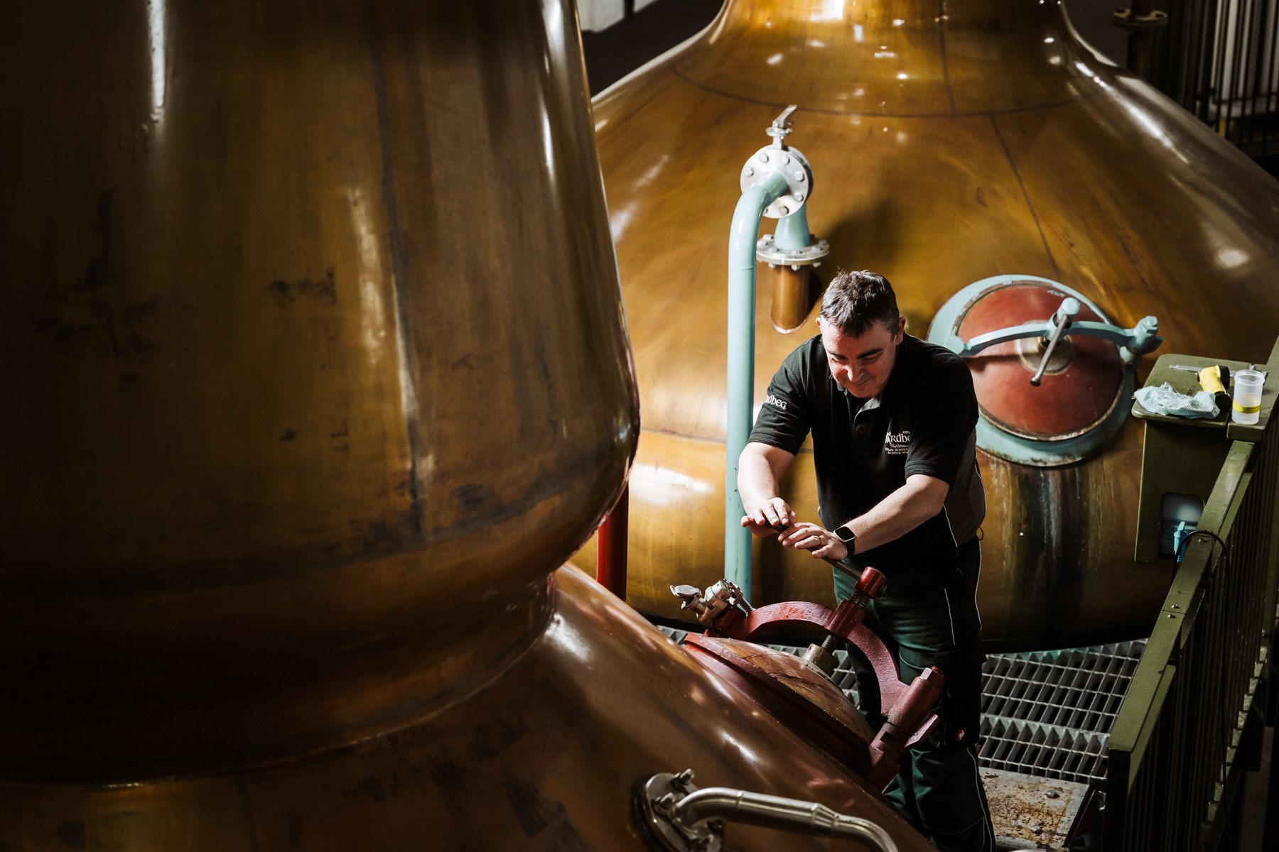 A member of the Ardbeg team at work among the copper stills