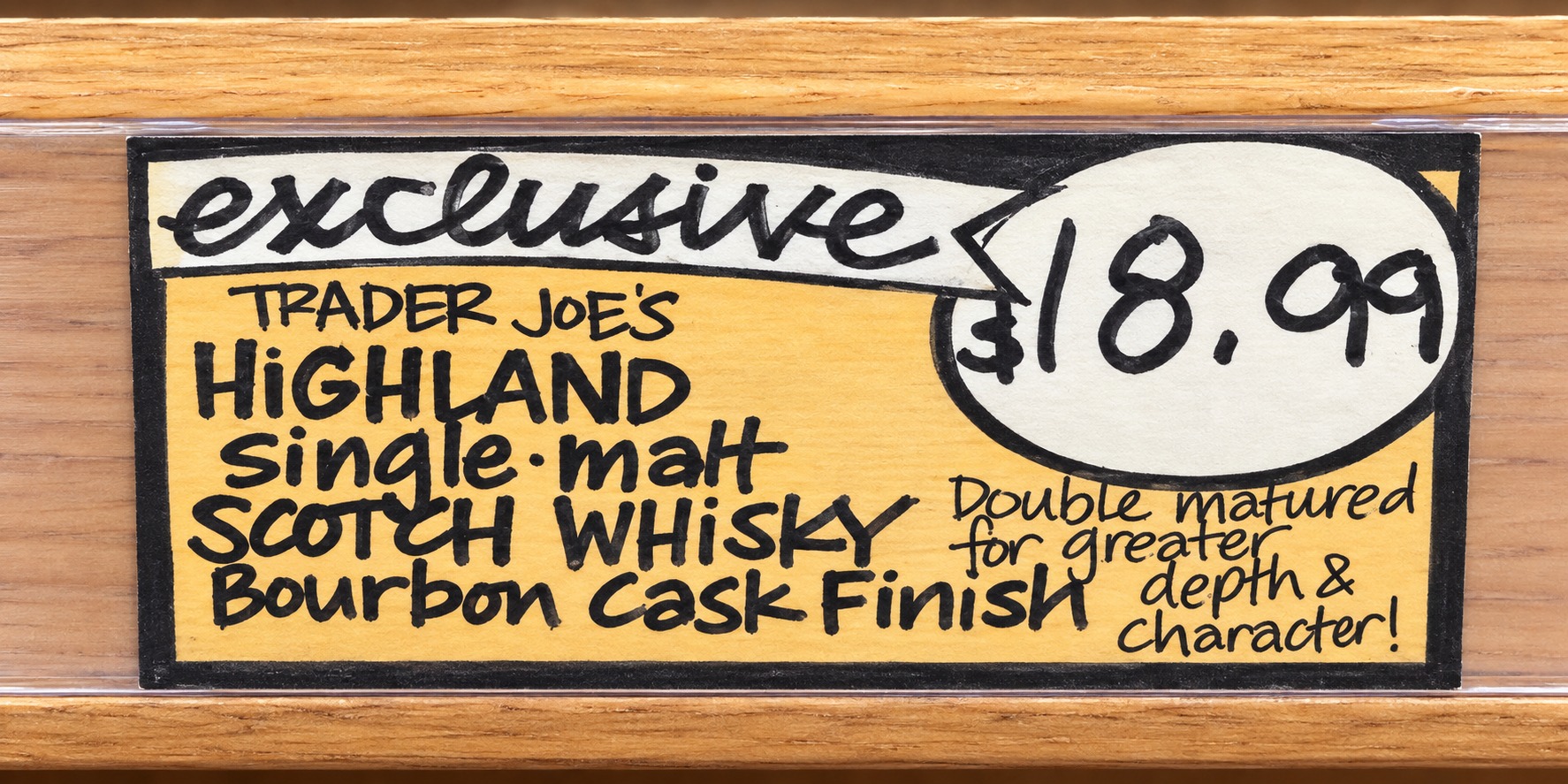 AI-retouched Trader Joe’s Highland Bourbon Cask Finish shelf sign showing 18.99 dollars